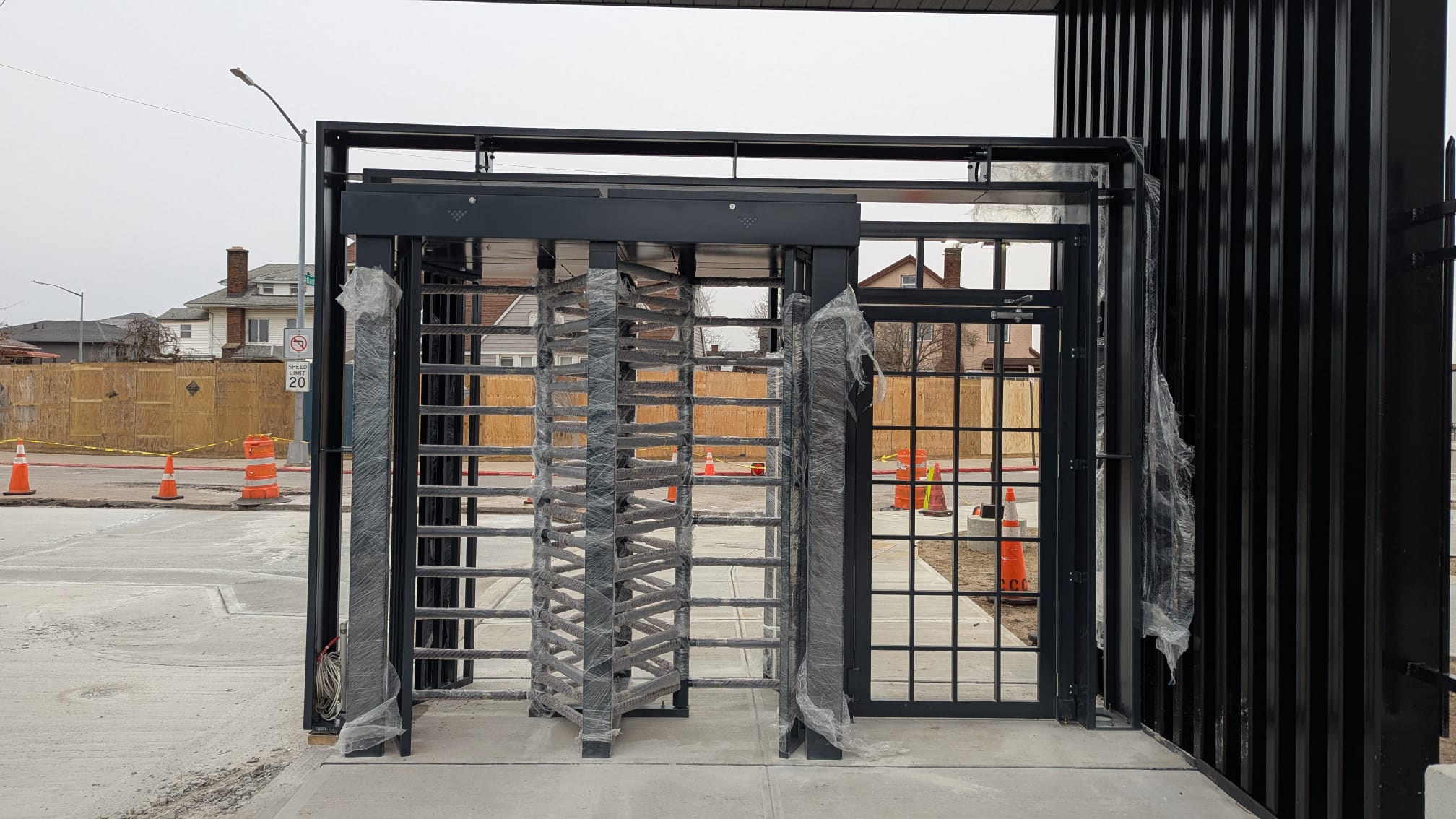 A tandem TitanX turnstiles with an emergency door to its right.