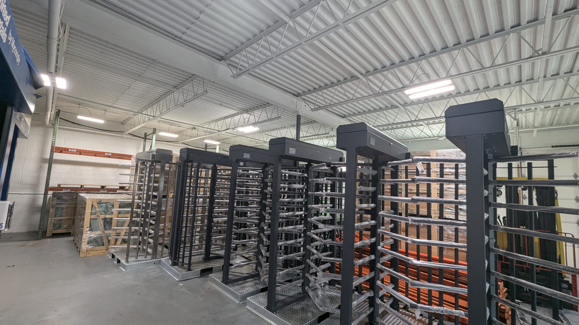 Single stainless steel XRX turnstiles in a warehouse, ready for shipping.